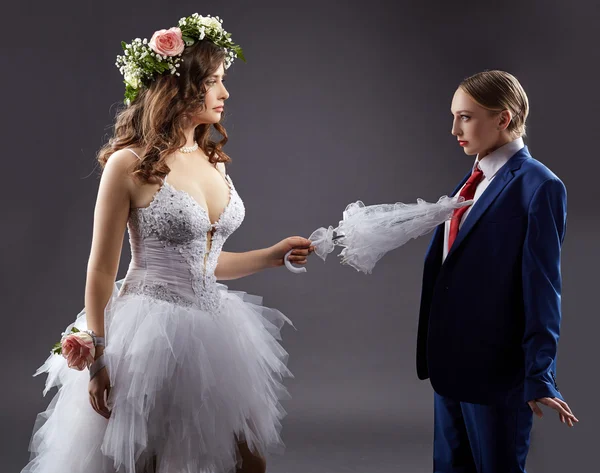 Gay marriage. Sexy bride pokes groom with umbrella — Stock Photo, Image