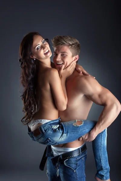 Happy topless lovers posing in trendy jeans Royalty Free Stock Images