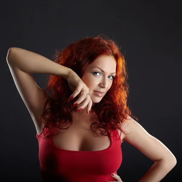 Seductive red-haired woman on gray background — Stock Photo, Image