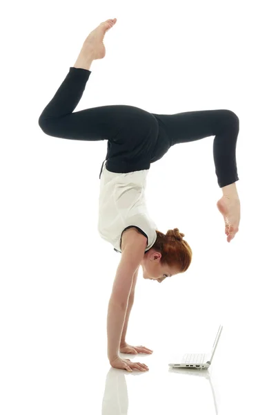 Multitasking. Girl doing handstand with laptop — Stock Photo, Image