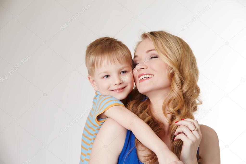 Portrait of happy mother hugging her son