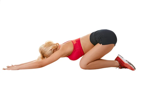 Side view of slim blonde doing fitness exercise — Stock Photo, Image