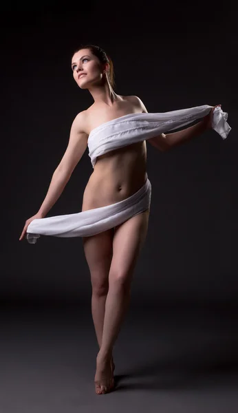 Nude woman posing with cloth covering her body — Stock Photo, Image