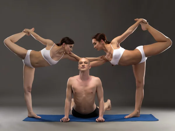 Yoga composition of flexible people posing — Stock Photo, Image