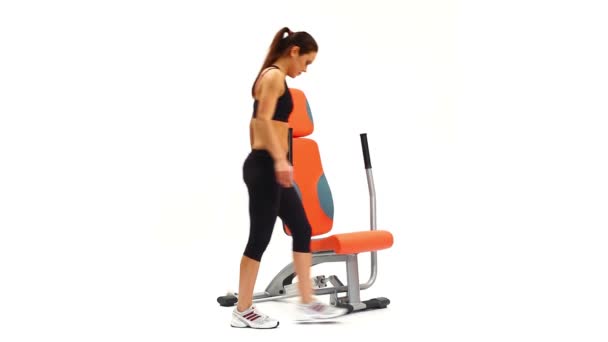 Brunette woman on hydraulic exerciser — Wideo stockowe