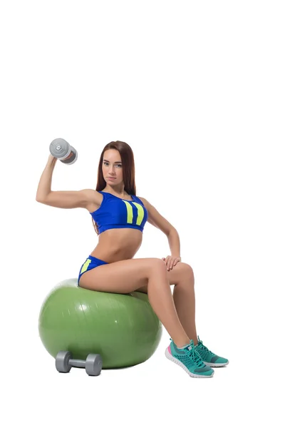 Slim brunette exercising with dumbbells in fitness — Stock Photo, Image