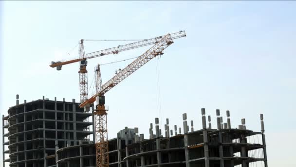 Construction site. View of cranes on sky backdrop — Stock Video