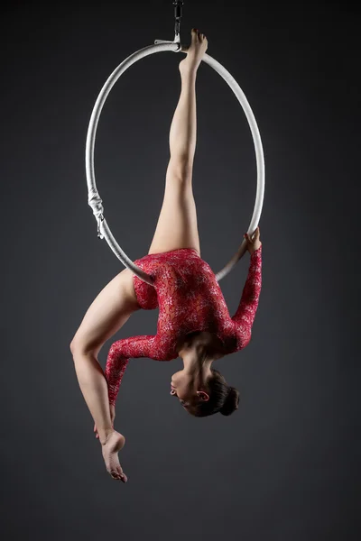 Sexy female acrobat exercising with hanging hoop — Stock Photo, Image