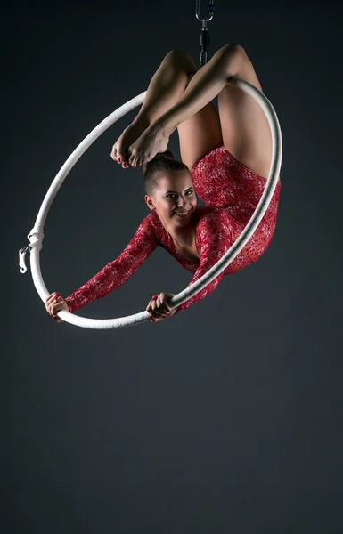 Happy female acrobat performs with hanging hoop — Stock Photo, Image