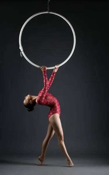 Studio shot of graceful acrobat performs with hoop — Stock Photo, Image