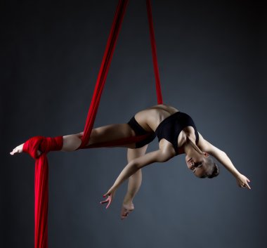Image of elegant girl doing acrobatic trick  clipart
