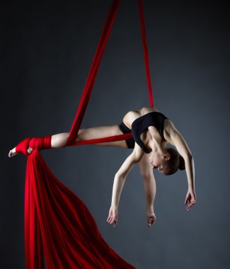 Graceful acrobat posing while doing trick