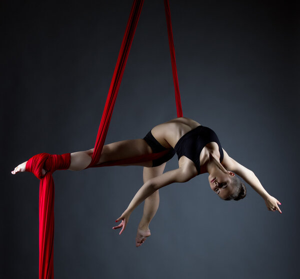 Image of elegant girl doing acrobatic trick 