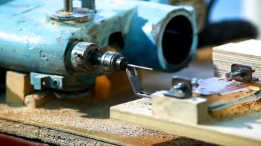 Drilling a plywood at wood factory close-up