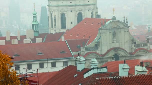 Old Prague roofs at autumn morning with smoke — Stock Video