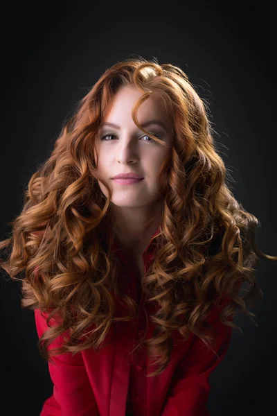 Sexy redhead babe posing in unbuttoned red blouse — Stock Photo, Image