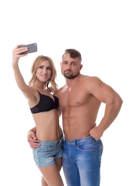 Loira fazendo selfie e seu namorado entediado — Fotografia de Stock
