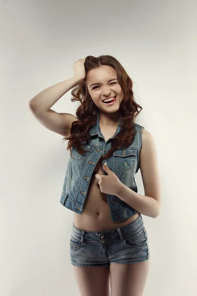 Studio shot of funny teen model winks at camera — Stock Photo, Image