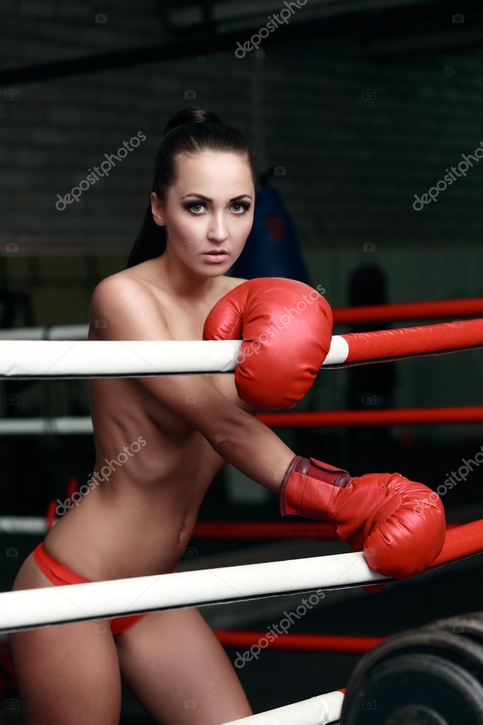 An athletic woman in boxers gloves posing for the camera Stock