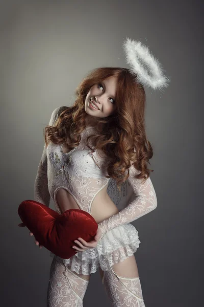 Smiling red-haired beauty posing in angel costume — Stock Photo, Image