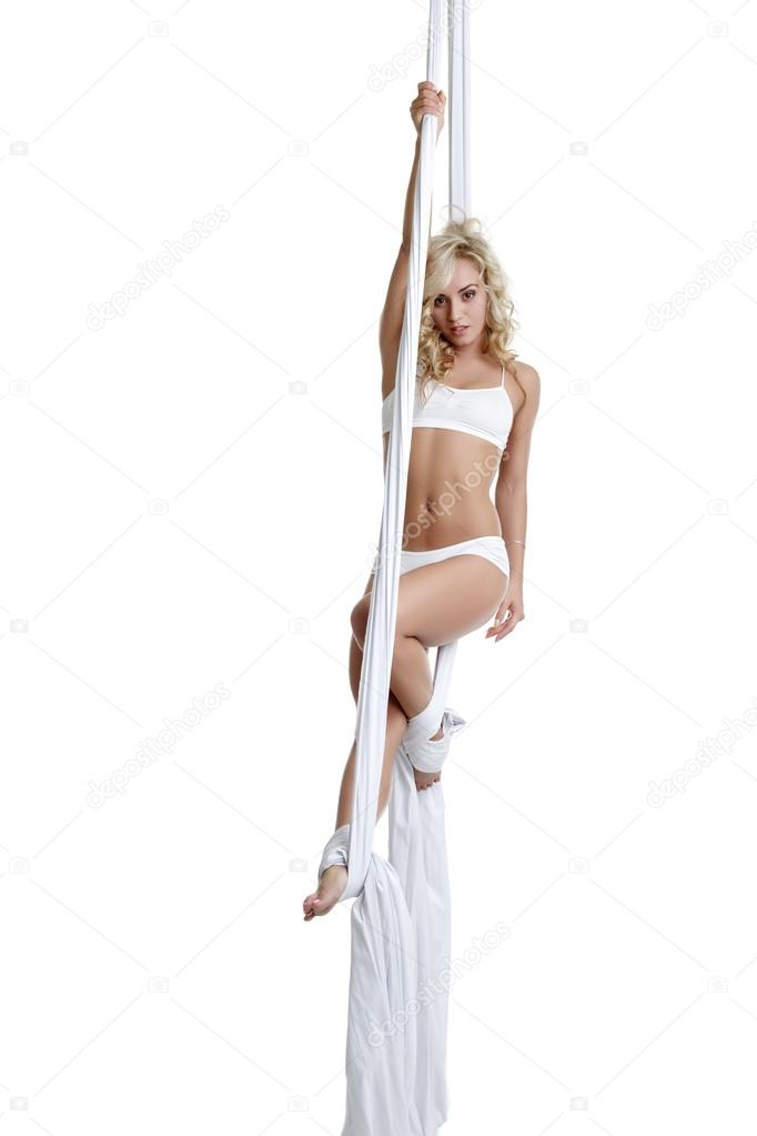 Alluring blonde dancing on aerial silks