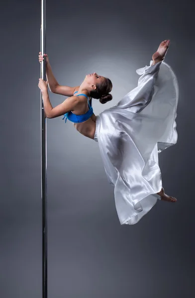 Sexy dancer turning gracefully around pole — Stock Photo, Image