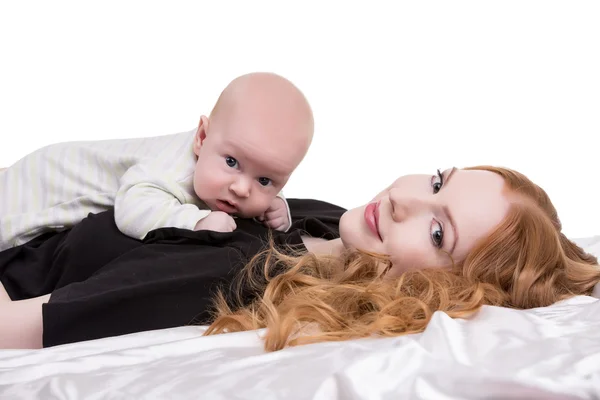 Lovely red-haired woman with baby on chest — Stock Photo, Image