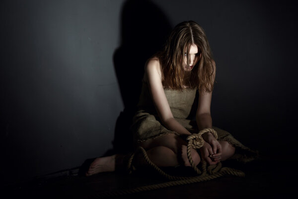 Kidnaping concept. Exhausted model with tied hands