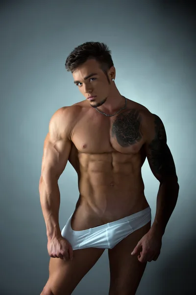 Sexy tattooed bodybuilder in provocative pose — Stock Photo, Image