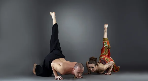 Experienced instructors posing while doing asana — Stock Photo, Image