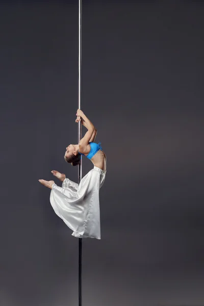 Sexy dancer bent gracefully while dancing on pylon — Stock Photo, Image