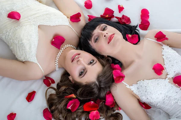 Top view of beautiful dark-haired brides lying — Stock Photo, Image