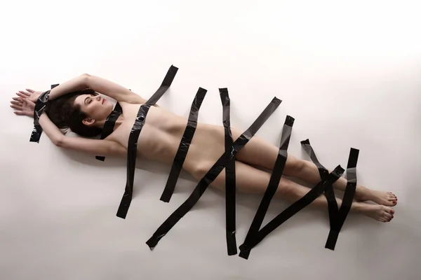 BDSM. Nude woman with duct tape on her body — Stock Photo, Image