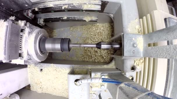 View of drill plunges into boards and shavings fly — Stock Video