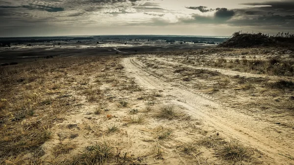 Rolled road in a field — Stock Photo, Image