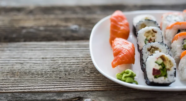 Various sushi on white plate — Stock Photo, Image