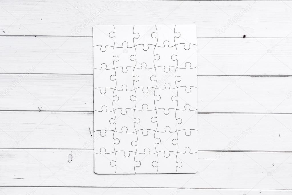 white completed puzzle on white wooden table