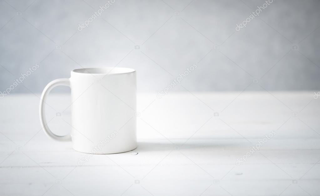 white cup on a table