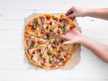 güzel pizza bir bölümünü alarak eller