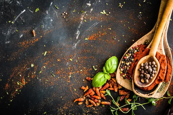 Wooden spoons with spices and herbs — Stock Photo, Image