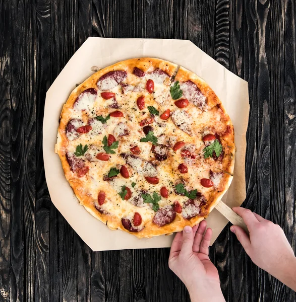 güzel pizza bir bölümünü alarak eller