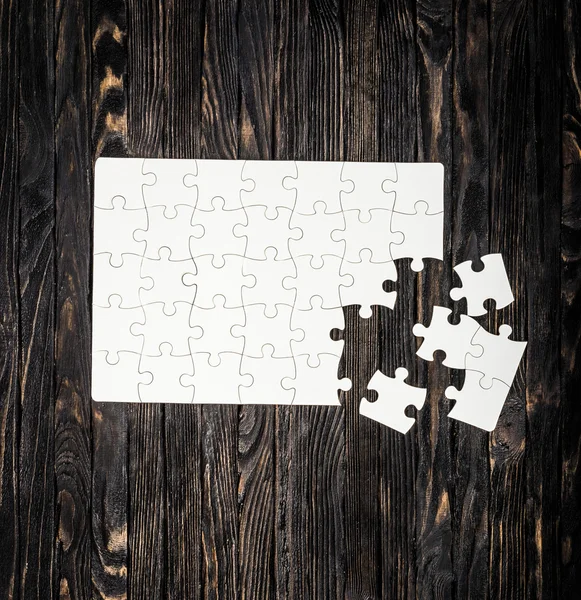 White uncompleted puzzle from one side — Stock Photo, Image