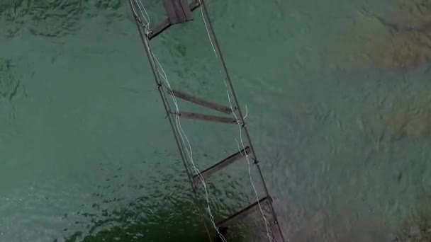 Destroyed suspension bridge over river in Carpathians — Stock Video