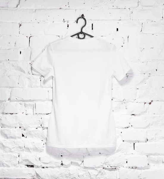 Muro di mattoni imbiancato con t-shirt bianca su appendino — Foto Stock