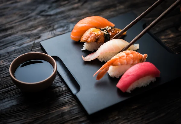 Close up of sashimi sushi set with chopsticks and soy — Stock Photo, Image