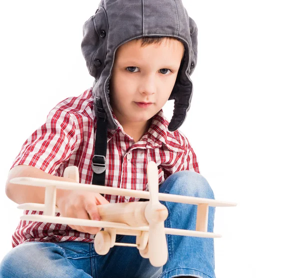 Kleiner Junge mit Pilotenhut und Spielzeugflugzeug — Stockfoto