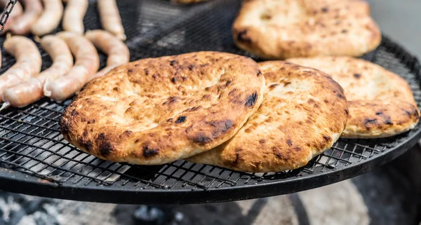 Flapjacks with golden crust preparing on grill — Stock Photo, Image