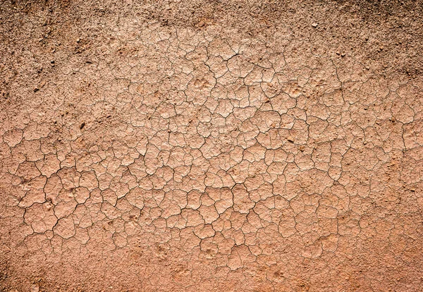 Marrón seco agrietado tierra — Foto de Stock