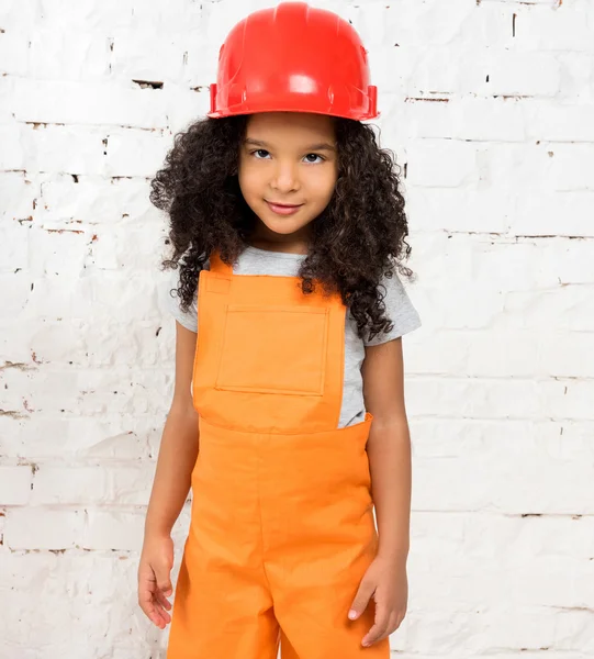 Little girl in orange repairmen uniform — Stock Photo, Image