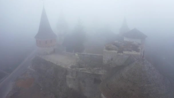 Drone aerial view of Kamianets-Podilskyi castle in Ukraine under the fog — Stock Video